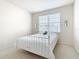 Bedroom with white metal bed frame and window with blinds at 1134 Tapestry Dr, Celebration, FL 34747