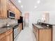 Kitchen with stainless steel appliances and wood cabinets at 1134 Tapestry Dr, Celebration, FL 34747