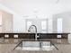 Modern kitchen sink and granite countertop with open view to living area at 1134 Tapestry Dr, Celebration, FL 34747