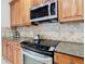 Kitchen detail showing modern gas cooktop and microwave at 1134 Tapestry Dr, Celebration, FL 34747