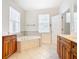 Bathroom with corner tub, double vanity, and tile flooring at 1134 Tapestry Dr, Celebration, FL 34747