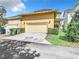 Attached garage with driveway and landscaping at 1134 Tapestry Dr, Celebration, FL 34747