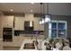 Modern kitchen with white cabinets, stainless steel appliances, and an island at 3857 Carrick Bend Dr, Kissimmee, FL 34746