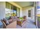 Relaxing screened porch with wicker furniture and a view at 891 Ocean Course Ave # 0, Davenport, FL 33896