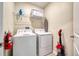 Convenient laundry room with washer, dryer, and shelving at 891 Ocean Course Ave # 0, Davenport, FL 33896