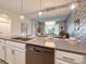 Open concept kitchen with island and view into dining area at 891 Ocean Course Ave # 0, Davenport, FL 33896