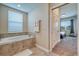 Bathroom boasts a large garden tub and view into bedroom at 891 Ocean Course Ave # 0, Davenport, FL 33896