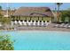 Relaxing pool area with thatched cabana and lounge chairs at 891 Ocean Course Ave # 0, Davenport, FL 33896