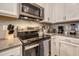 Stainless steel appliances and modern cabinetry in this well-equipped kitchen at 891 Ocean Course Ave # 0, Davenport, FL 33896
