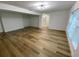 Living room with hardwood floors and view of bathroom at 1204 Lake Elbert Se Dr, Winter Haven, FL 33880