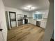 Modern kitchen with stainless steel appliances and light wood flooring at 1204 Lake Elbert Se Dr, Winter Haven, FL 33880