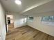 Bright and airy bedroom with light wood flooring and access to the kitchen at 1204 Lake Elbert Se Dr, Winter Haven, FL 33880