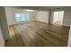 Open living room with light wood floors and access to other rooms at 1204 Lake Elbert Se Dr, Winter Haven, FL 33880