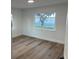 Bedroom with a lake view and light wood floors at 1204 Lake Elbert Se Dr, Winter Haven, FL 33880
