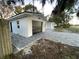 Attached garage with a paved driveway and newly painted exterior at 1204 Lake Elbert Se Dr, Winter Haven, FL 33880