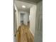 Light and bright hallway with updated wood-look flooring at 1204 Lake Elbert Se Dr, Winter Haven, FL 33880