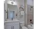 Updated bathroom features a white vanity and a neutral color scheme at 1670 Houston St, Kissimmee, FL 34743