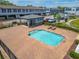 Community pool with a covered patio and lounge chairs at 1670 Houston St, Kissimmee, FL 34743