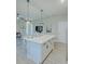 Open concept kitchen with white cabinets, quartz countertops, and island seating at 1670 Houston St, Kissimmee, FL 34743