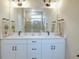 Elegant bathroom with double vanity and large mirror at 1670 Houston St, Kissimmee, FL 34743