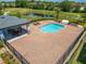 Community pool area with patio and surrounding landscaping at 1670 Houston St, Kissimmee, FL 34743