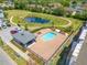 Aerial view of community pool, cabana, and surrounding landscape at 1680 Houston St, Kissimmee, FL 34743