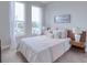Bedroom with queen bed, neutral decor, and ample natural light at 1690 Houston St, Kissimmee, FL 34743