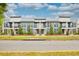 Three-unit modern building with stone accents and balconies at 1700 Houston St, Kissimmee, FL 34743