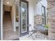 Front entry with small patio seating and interior stairs at 1700 Houston St, Kissimmee, FL 34743