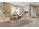 Sunlit living room, sectional sofa, coffee table, and backyard access at 3060 Gatsby St, Kissimmee, FL 34746