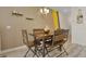 Modern dining area with a wood table and statement wall at 3060 Gatsby St, Kissimmee, FL 34746
