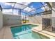 Inviting screened pool with safety fence and ample patio space at 3060 Gatsby St, Kissimmee, FL 34746