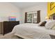 Bedroom with a queen-size bed and dresser, featuring a TV at 3060 Gatsby St, Kissimmee, FL 34746