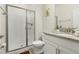 Clean bathroom with a shower, toilet, and granite countertop at 3060 Gatsby St, Kissimmee, FL 34746