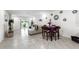 Open dining area with dark wood table and chairs, next to living room at 2928 Sunridge Loop, Saint Cloud, FL 34771