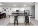 Kitchen island with granite countertop and two dark wood stools at 2928 Sunridge Loop, Saint Cloud, FL 34771