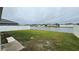 Spacious backyard with a pond view and a white fence at 305 Cascara Ln, Auburndale, FL 33823