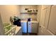 Laundry room with washer, dryer, and shelving at 305 Cascara Ln, Auburndale, FL 33823