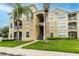 Condo building with palm trees and landscaping at 2307 Butterfly Palm Way # 201, Kissimmee, FL 34747
