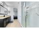 Modern bathroom featuring a walk-in shower, double vanity, and granite countertops at 8159 Roseville Blvd, Davenport, FL 33896