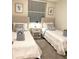 Bright bedroom featuring twin beds, a nightstand, and neutral decor at 3131 Paradox Circle # 207, Kissimmee, FL 34746