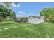 Landscaped backyard with spacious lawn and shed at 7920 Summer Ridge Pl, Orlando, FL 32819