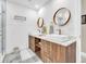 Contemporary bathroom with double vanity, wood cabinets, and modern lighting at 7920 Summer Ridge Pl, Orlando, FL 32819
