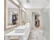 Modern bathroom with double sinks, walk-in closet, and large mirrors at 7920 Summer Ridge Pl, Orlando, FL 32819