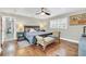 Spacious bedroom with hardwood floors, a king-size bed, and an en-suite bathroom at 7920 Summer Ridge Pl, Orlando, FL 32819