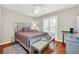 Bright bedroom with queen-size bed, wood floors and plantation shutters at 7920 Summer Ridge Pl, Orlando, FL 32819