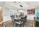 Elegant dining room features a large table, chandelier, and hardwood floors at 7920 Summer Ridge Pl, Orlando, FL 32819
