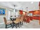 Gourmet kitchen with wood cabinets, granite counters, and breakfast bar at 7920 Summer Ridge Pl, Orlando, FL 32819