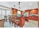 Modern kitchen with granite island, stainless steel appliances, and wood cabinetry at 7920 Summer Ridge Pl, Orlando, FL 32819