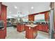 Updated kitchen features island, stainless steel appliances, and ample counter space at 7920 Summer Ridge Pl, Orlando, FL 32819